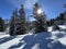 A magical play of sunlight and shadow during the alpine winter on the snowy slopes above the mountine Swiss tourist