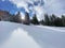 A magical play of sunlight and shadow during the alpine winter on the snowy slopes of the Churfirsten mountain range