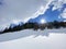 A magical play of sunlight and shadow during the alpine winter on the snowy slopes of the Churfirsten mountain range