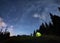 Magical starry night at a campsite in the mountains during summer time