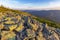 Magical summer sunset in the Carpathian mountains with over the rocky outcrops of the Gorgany region. Picturesque sunset in the mo