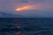 Magical sunlight in the dark clouds over the wavy lake of Sevan