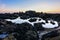 Magical sunset on the rocky beach in Porto, Portugal, Europe