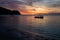 Magical sunset with traditional boat at a deserted beach near surf spot scar reef on Sumbawa, Indonesia