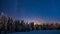 Magical winter forest under the mesmerizing starry sky at sunset