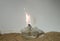 Magnesium powder burns with white sparks in an almost invisible flame from a burner.