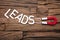 Magnet Pulling Leads Letter Blocks On Wooden Table