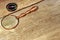 Magnetic Compass and Retro Magnifying Glass on grunge wood board