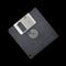 Magnetic floppy disc on a black background.