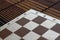 Magnetic wooden empty chessboard with white and brown cells