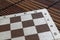 Magnetic wooden empty chessboard with white and brown cells