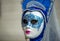 Magnificent blue mask in Venice Carnival, Italy, closeup