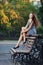 Magnificent brunette sits on bench