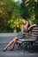 Magnificent brunette sits on bench