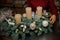 Magnificent Christmas composition of green fir branches decorated with shiny toys and candles