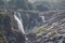 A magnificent fall view in India from the distance. Rock structure has covered most of the area around the fall