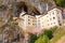 Magnificent landscape of medieval Predjama castle Slovene. Predjamski grad. Castle at the cave mouth.