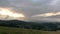 Magnificent mountain landscape at sunrise. Storm clouds in the sky.