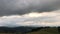 Magnificent mountain landscape at sunrise. Storm clouds in the sky.