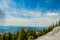 Magnificent panoramic view the coniferous forest on the mighty Carpathians Mountains and beautiful blue sky background. Beauty of