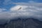 A magnificent peak in the Himalayas rising beyond the clouds.