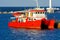 A magnificent red catamaran for sea walks in open sea is moored