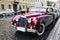 The magnificent retrocar the Jaguar to stand on the ancient street of Budapest