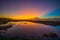 Magnificent seascape. Beach at sunset during low tide. Sunset golden hour. Sunlight reflection in water. Colorful sky. Bingin