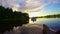 Magnificent sunset on peaceful river, tourists in boat, nature