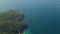 Magnificent view of an aerial tramway with cable cars moving over blue ocean.