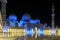 Magnificent view of the inner area of The Sheikh Zayed Grand Mosque, beautifully illuminated with blue light in the evening