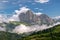 Magnificent view of Sassolungo massif and Gardena valley covered by white clouds, Dolomites, Italy