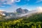 Magnificent view of Sassolungo massif and Gardena valley covered by white clouds, Dolomites, Italy