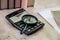 Magnifier on a calculator, smartphone, notepad and books. Close-up.