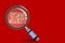 Magnifier Glass on text Scam Alert on red background. 3d illustration or 3d rendering.