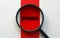 Magnifier with text UPCOMING on the white and red background