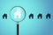 Magnifier zooming in on house icon on background. Home and property search concept. 3D Rendering
