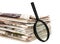 Magnify glass over a stack of newspaper