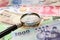 Magnifying glass and Background of asian currency