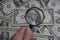 Through the magnifying glass of the dollar is a portrait of late American President George Washington.