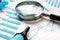 Magnifying glass and financial documents. Audit and accounting