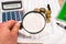 magnifying glass with financial documents, coin, notepad, calculator