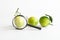 Magnifying glass and fresh limes. Examination of the quality and study of the beneficial properties of fruits. Checking and