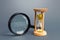 Magnifying glass and hourglass. Limited Search Concept. Find free time. Subscription, paid plan. Seek in short time. Speed and