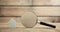 Magnifying glass with house on wooden background. Property inspection