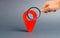 Magnifying glass is looking at red pointer location on a gray background. Concept of navigation and venue. Tourism and travel