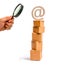 Magnifying glass is looking at the tower of cardboard boxes and an email symbol on top. concept of online sales, shopping