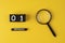 Magnifying glass magnifier glass search symbol on yellow background with copy space