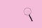 Magnifying glass on pastel pink background. Minimal creative search concept