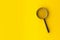 Magnifying glass with shadow on yellow background with copy space - minimal information search, find or exploration concept